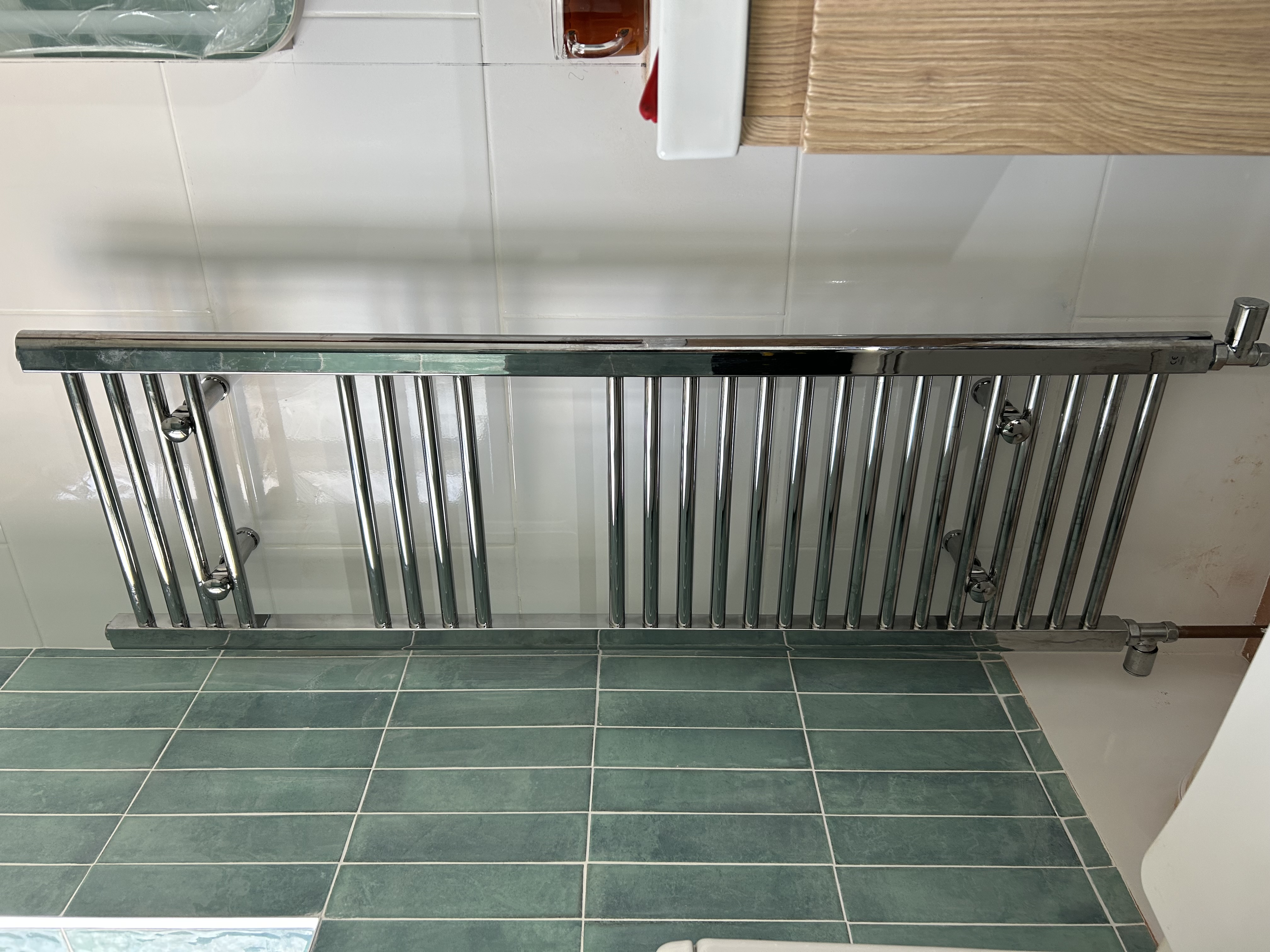 Chrome towel radiator in bathroom
